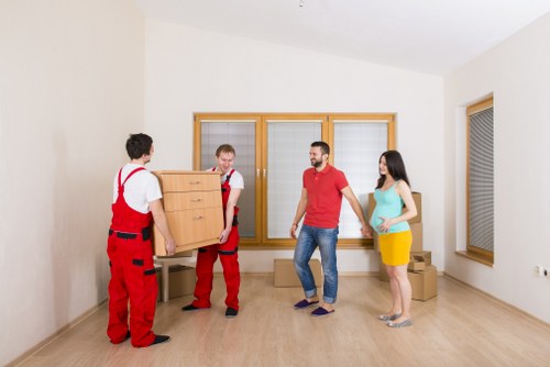 Professional movers handling furniture during a Falconwood move